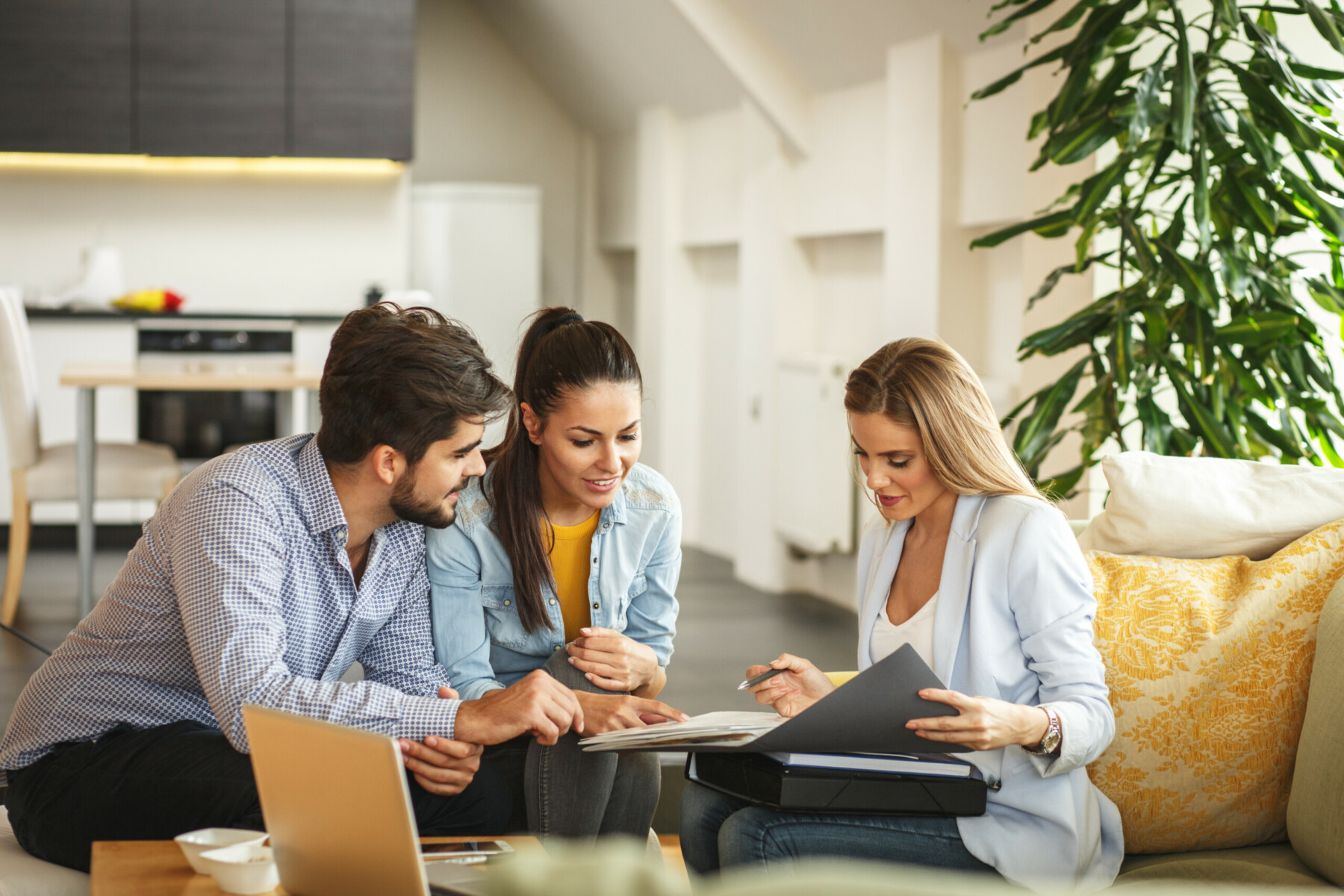 Female Real Estate Agent Offer Home Ownership And Life Insurance To Young Couple.